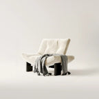 Fauteuil d'appoint contemporain en chenille noire capitonnée sans accoudoirs